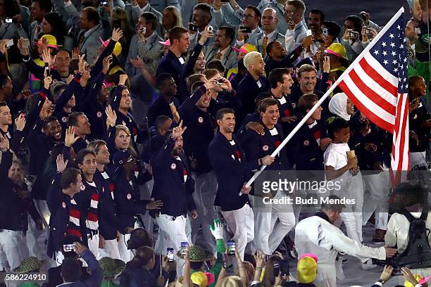 Flag bearer Michael Phelps of the United States and Ibtihaj Muhammad lead the U.S. Olympic Team during the Opening Ceremony of the Rio 2016 Olympic...