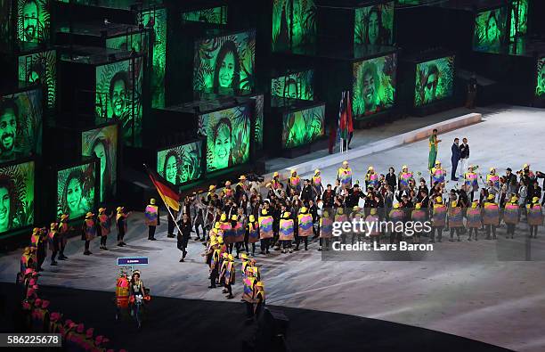 Flag bearer Timo Boll of Germany leads the team entering the stadium during the Opening Ceremony of the Rio 2016 Olympic Games at Maracana Stadium on...