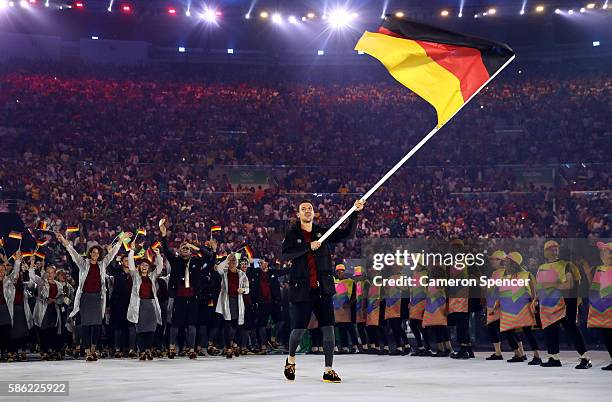 Timo Boll of Germany carries the flag during the Opening Ceremony of the Rio 2016 Olympic Games at Maracana Stadium on August 5, 2016 in Rio de...