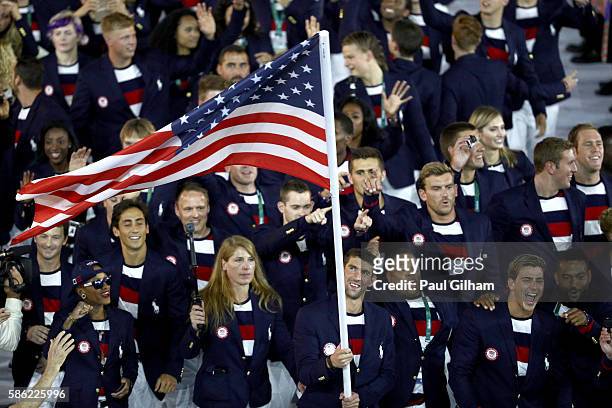 Flag bearer Michael Phelps of the United States leads the U.S. Olympic Team during the Opening Ceremony of the Rio 2016 Olympic Games at Maracana...