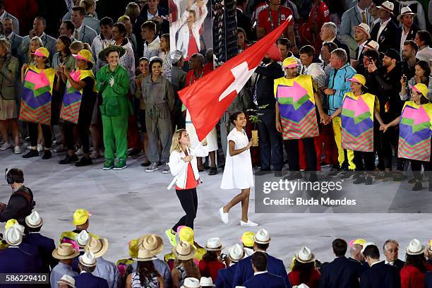 Flag bearer Giulia Steingruber of Switzerland leads her team during the Opening Ceremony of the Rio 2016 Olympic Games at Maracana Stadium on August...