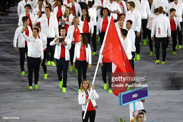 Flag bearer Giulia Steingruber of Switzerland leads her team during the Opening Ceremony of the Rio 2016 Olympic Games at Maracana Stadium on August...