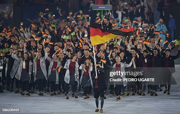 Germany's flagbearer Timo Boll leads his delegation during the opening ceremony of the Rio 2016 Olympic Games at the Maracana stadium in Rio de...