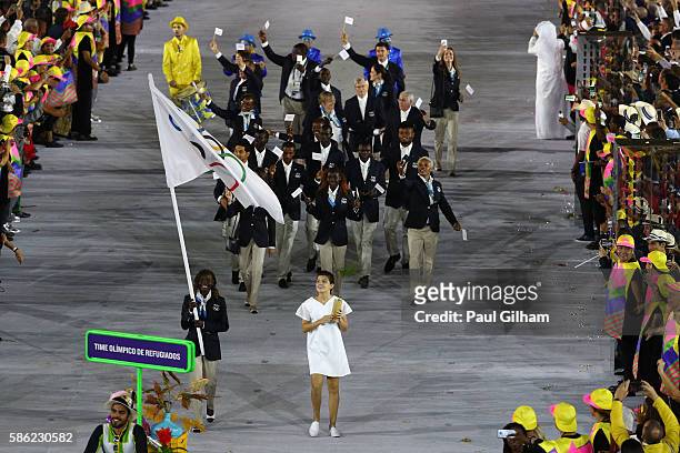 Flag bearer Rose Lokonyen Nathike of the Refugee Olympic Team leads her team during the Opening Ceremony of the Rio 2016 Olympic Games at Maracana...