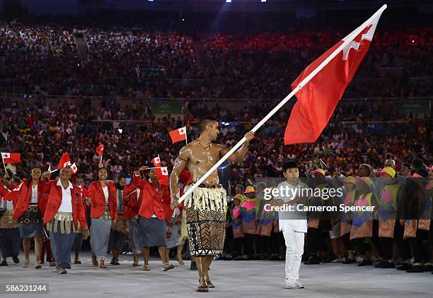 Pita Nikolas Aufatofua of Tonga carries the flag during the Opening Ceremony of the Rio 2016 Olympic Games at Maracana Stadium on August 5, 2016 in...