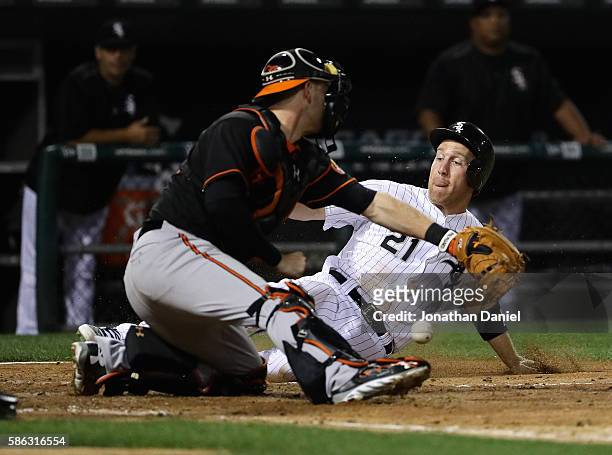 Todd Frazier of the Chicago White Sox slides in to score a run in the 4th inning as Matt Wieters of the Baltimore Orioles drops the ball at U.S....