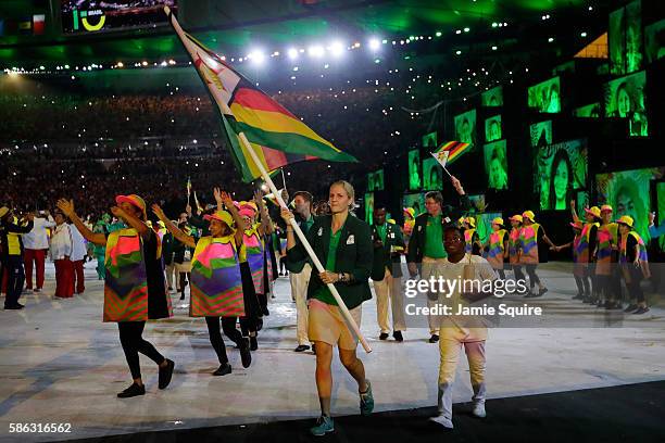 Flab bearer Kirsty Coventry of Zimbabwe leads her team during the Opening Ceremony of the Rio 2016 Olympic Games at Maracana Stadium on August 5,...