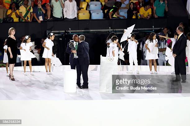 President Thomas Bach presents the Olympic Laurel to Kip Keino during the Opening Ceremony of the Rio 2016 Olympic Games at Maracana Stadium on...