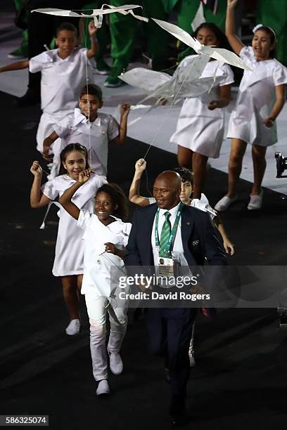 Kipchoge Keino jogs to stage to receive the Olympic Laurel during the Opening Ceremony of the Rio 2016 Olympic Games at Maracana Stadium on August 5,...