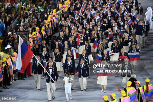 Russia's flagbearer Sergei Tetyukhin leads his delegation during the opening ceremony of the Rio 2016 Olympic Games at the Maracana stadium in Rio de...