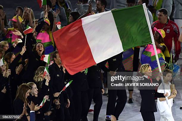 Italy's Federica Pellegrini carries their country's flag as they lead teammates into the stadium during the opening ceremony of the Rio 2016 Olympic...