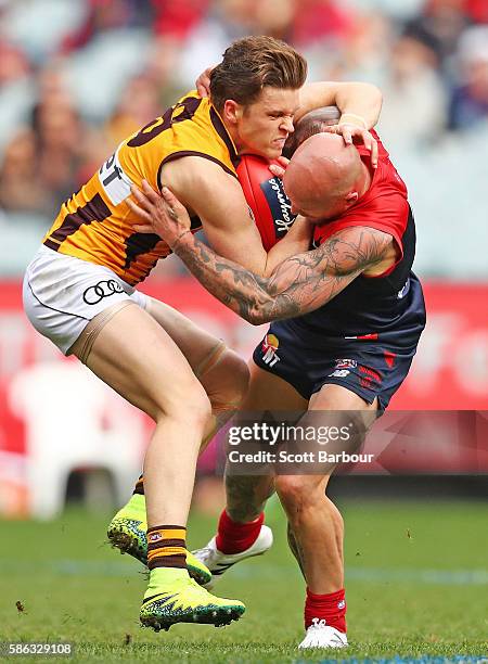 Taylor Duryea of the Hawks and Nathan Jones of the Demons compete for the ball during the round 20 AFL match between the Melbourne Demons and the...