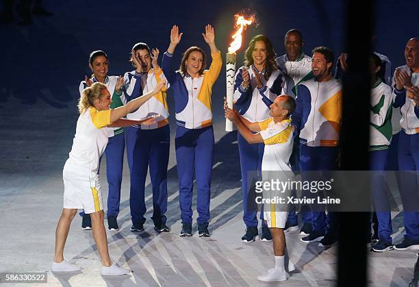 Hortencia Basquete and Vanderlei Cordeiro De Lima during the Olympic Games opening ceremony at Maracana Stadium on August 5, 2016 in Rio de Janeiro,...