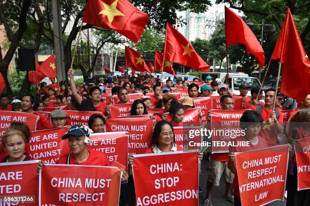 Filipino and Vietnamese protesters display anti-China placards and Vietnamese national flags during a call on China to respect their rights in the...