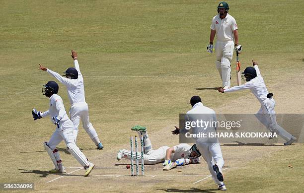 Sri Lanka's captain Angelo Mathews, 2R), wicketkeeper Dinesh Chandimal,, cricketer Kusal Mendis and cricketer Kaushal Silva celebrate the wicket of...