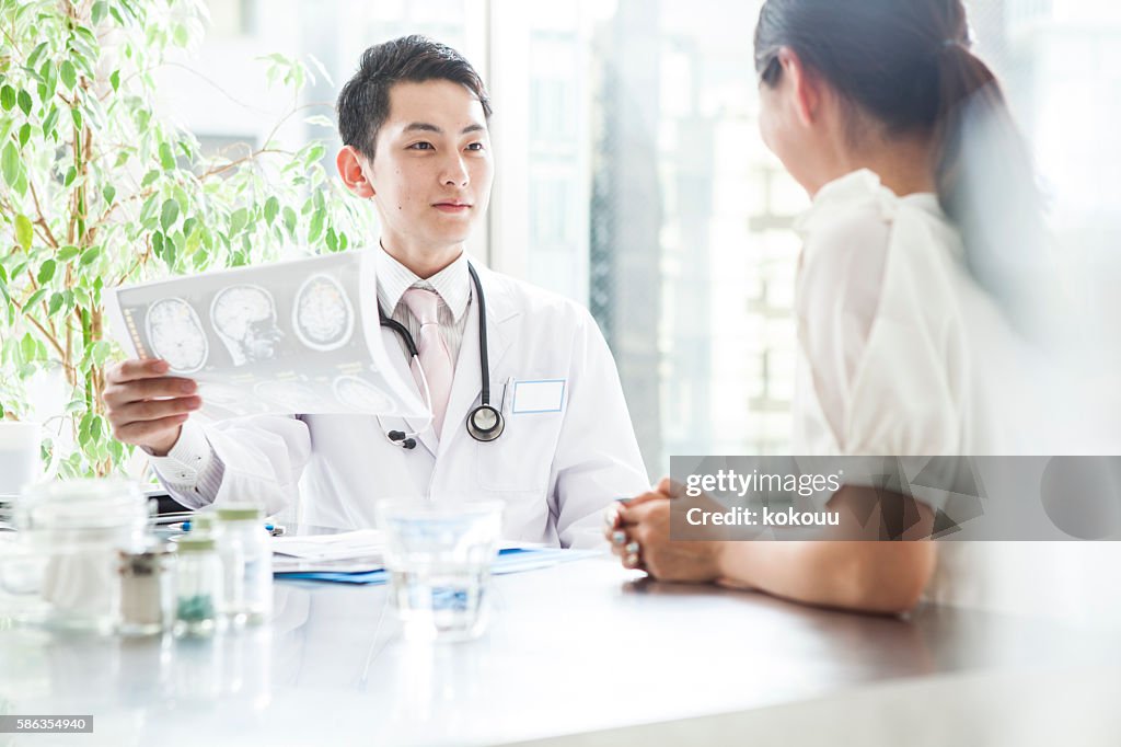 Doctor talking to patient while looking at the X-ray photo
