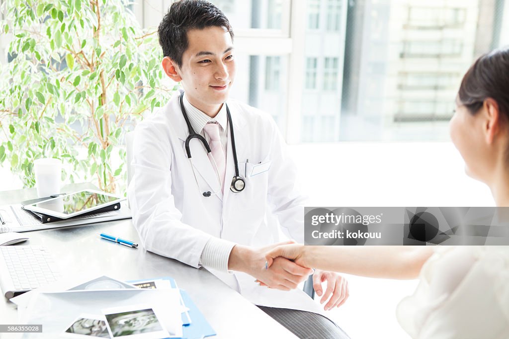 Doctor shaking hands with a patient at the hospital