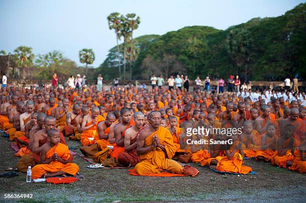 buddhist monks praying in angkor wat - man reliable learning stock pictures, royalty-free photos & images