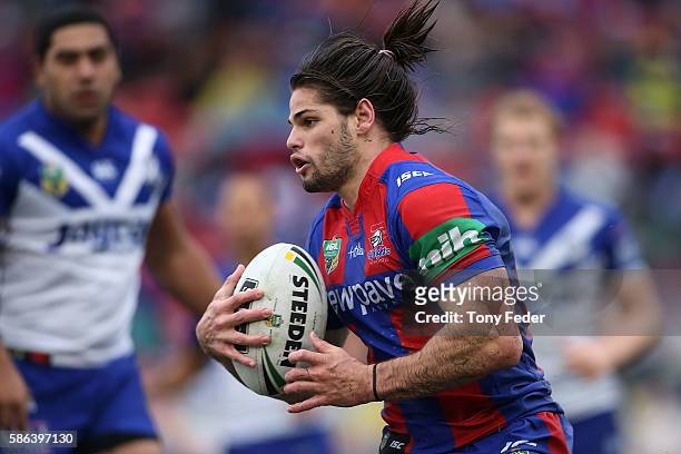 Jake Mamo of the Knights runs the ball during the round 22 NRL match between the Newcastle Knights and the Canterbury Bulldogs at Hunter Stadium on...