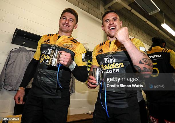 Beauden Barrett and TJ Perenara celebrate in the changing room after winning the 2016 Super Rugby Final match between the Hurricanes and the Lions at...