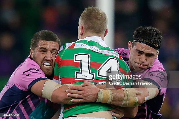 Jason Clark of the Rabbitohs is tackled during the round 22 NRL match between the Melbourne Storm and the South Sydney Rabbitohs at AAMI Park on...