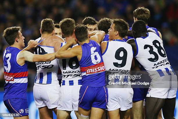 Players get involved in a melee during the round 20 AFL match between the Western Bulldogs and the North Melbourne Kangaroos at Etihad Stadium on...