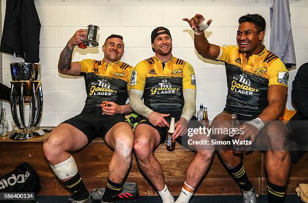 Perenara, Cory Jane and Julian Savea of the Hurricanes celebrate in the changing room after the Hurricanes won the 2016 Super Rugby Final match...