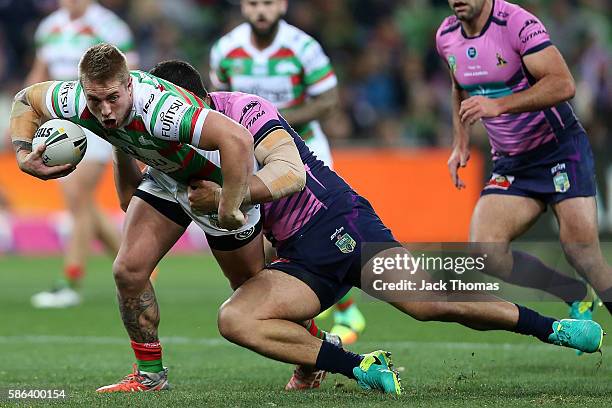 Aaron Gray of the Rabbitohs is tackled during the round 22 NRL match between the Melbourne Storm and the South Sydney Rabbitohs at AAMI Park on...