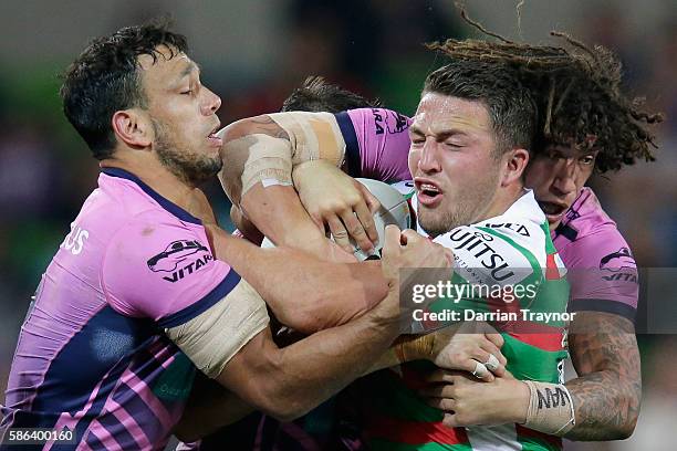 Sam Burgess of the Rabbitohs is tackled during the round 22 NRL match between the Melbourne Storm and the South Sydney Rabbitohs at AAMI Park on...