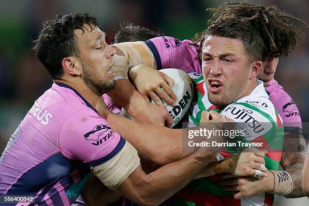 Sam Burgess of the Rabbitohs is tackled during the round 22 NRL match between the Melbourne Storm and the South Sydney Rabbitohs at AAMI Park on...