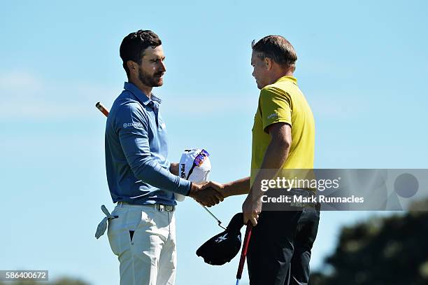 James Morrison of England shakes hands with Alejandro Canizares of Spain after winning their match on hole 16 on day three of the Aberdeen Asset...