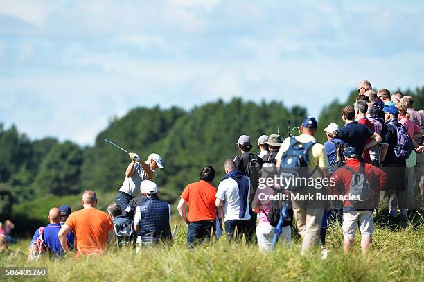 Alex Noren of Sweden is surrounded by a crowd as he takes his second shot on hole 15 on day three of the Aberdeen Asset Management Paul Lawrie...
