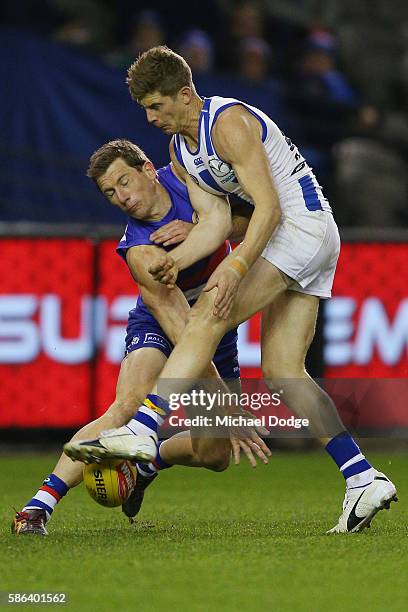 Dale Morris of the Bulldogs tackles Nick Dal Santo of the Kangaroos during the round 20 AFL match between the Western Bulldogs and the North...