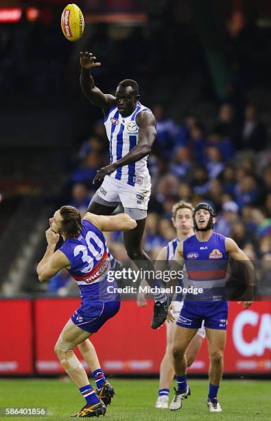 Majak Daw of the Kangaroos competes for the ball over Joel Hamling of the Bulldogs during the round 20 AFL match between the Western Bulldogs and the...