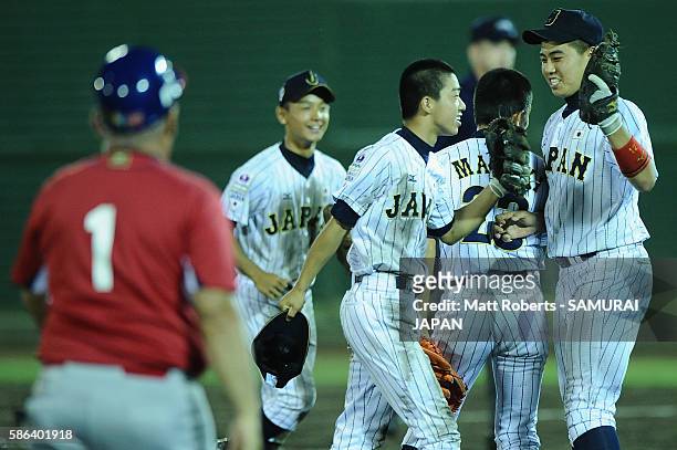 Shota Katekaru of Japan celebrates with Yumeto Taguchi of Japan after the top half of the nineth inning in the super round game between Japan and...