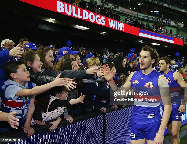 Marcus Bontempelli of the Bulldogs celebrates the win with fans during the round 20 AFL match between the Western Bulldogs and the North Melbourne...