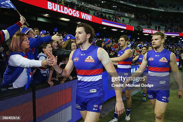 Marcus Bontempelli of the Bulldogs celebrates the win with fans during the round 20 AFL match between the Western Bulldogs and the North Melbourne...