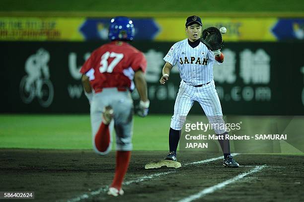 Shota Katekaru of Japan reaches out to catch the ball in the top half of the seventh inning in the super round game between Japan and Panama during...