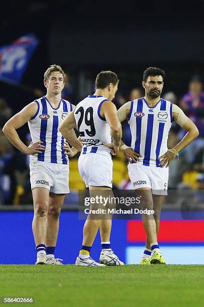 Trent Dumont of the Kangaroos Brent Harvey and Lindsay Thomas looks dejected after defeat during the round 20 AFL match between the Western Bulldogs...