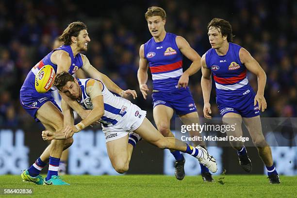 Marcus Bontempelli of the Bulldogs tackles Brad McKenzie of the Kangaroos during the round 20 AFL match between the Western Bulldogs and the North...