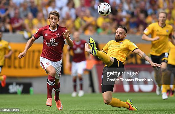 Giuliano Modica of Dresden is challenged by Jakub Sylvestr of Nuernberg during the Second Bundesliga match between SG Dynamo Dresden and 1. FC...