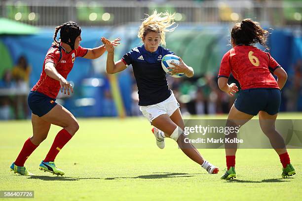 Marjorie Mayans of France is tackled by Marina Bravo and Elisabet Martinez of Spain during a Women's Pool B rugby match between France and Spain on...