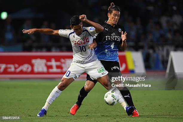 Dudu of Ventforet Kofu and Yusuke Igawa of Kawasaki Frontale compete for the ball during the J.League match between Kawasaki Frontale and Ventforet...