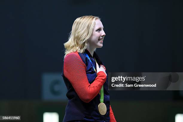 Virginia Thrasher of the United States puts her hand over her heart during the US national anthem after winning the gold medal in the 10m Air Rifle...