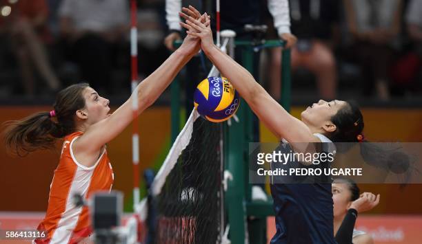 Netherlands' Yvon Belien vies with China's Xu Yunli during the women's qualifying volleyball match between China and the Netherlands at the...