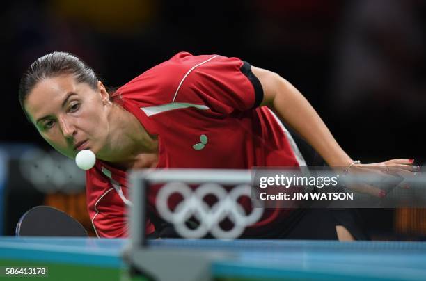 Russia's Maria Dolgikh hits a shot in her women's singles qualification round table tennis match at the Riocentro venue during the Rio 2016 Olympic...