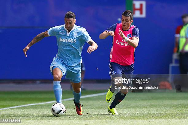 Filip Kostic of Hamburg challenges Geoff Cameron of Stoke City during the pre-season friendly match between Hamburger SV and Stoke City at...