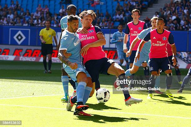 Albin Ekdal of Hamburg challenges Geoff Cameron of Stoke City during the pre-season friendly match between Hamburger SV and Stoke City at...