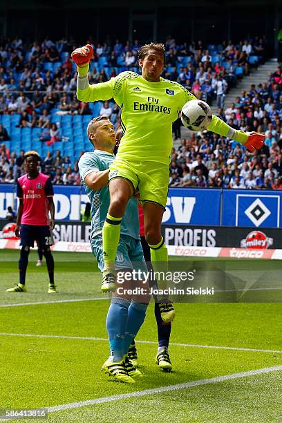 Rene Adler of Hamburg challenges Ryan Shawcross of Stoke City during the pre-season friendly match between Hamburger SV and Stoke City at...