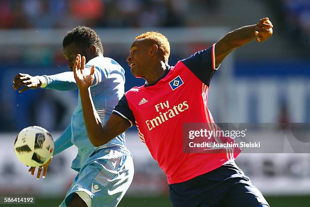 Cleber Reis of Hamburg challenges Mame Diouf of Stoke City during the pre-season friendly match between Hamburger SV and Stoke City at...